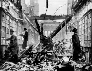 Men browsing books in the bomb-damaged library of Holland House, London, 1940 – photograph by Harrison, Fox Photos