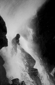 Phyllis Galembo photograph: a pilgrim standing under the Saut-d'Eau (Sodo) waterfall in Haiti