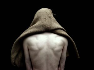 Mário Macilau, Telton Simbine (2), Faith series (2017): a man's bare back, his head covered by a burlap sack