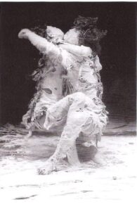 Eiko & Koma dancing entwined, covered in white paste and rags – photograph by Anne Nordmann
